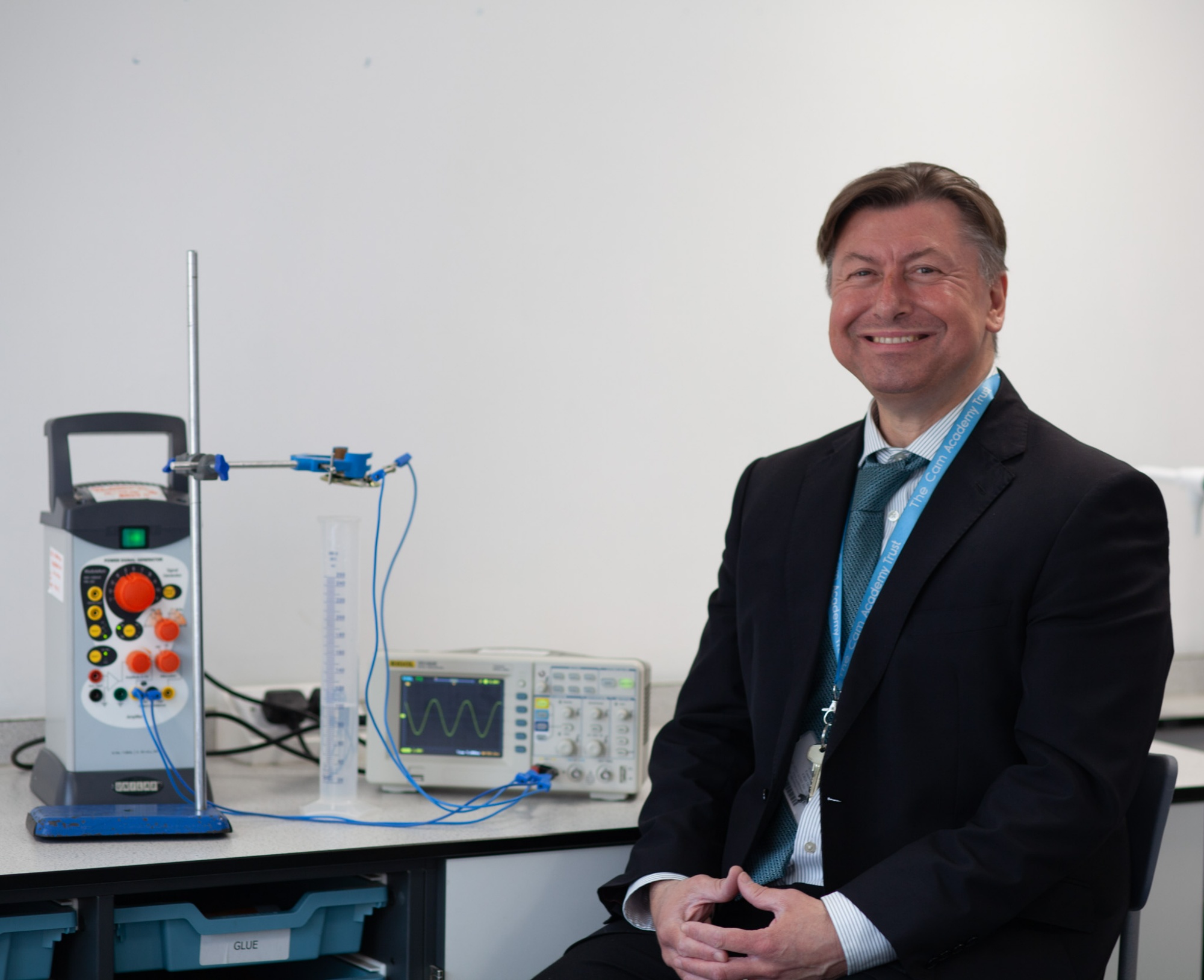 Man sat on chair in front of science equipment