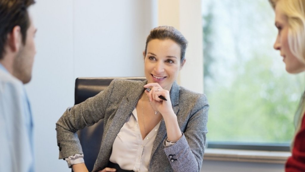 Woman sat at the table smiling